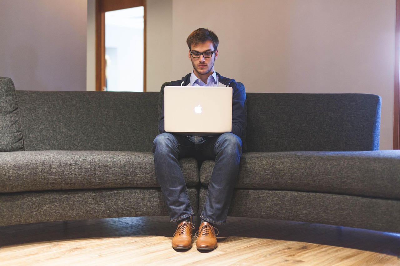 Man, laptop, businessman — Futures Trading Discounts 101: A Beginner's Guide to Cutting Costs
